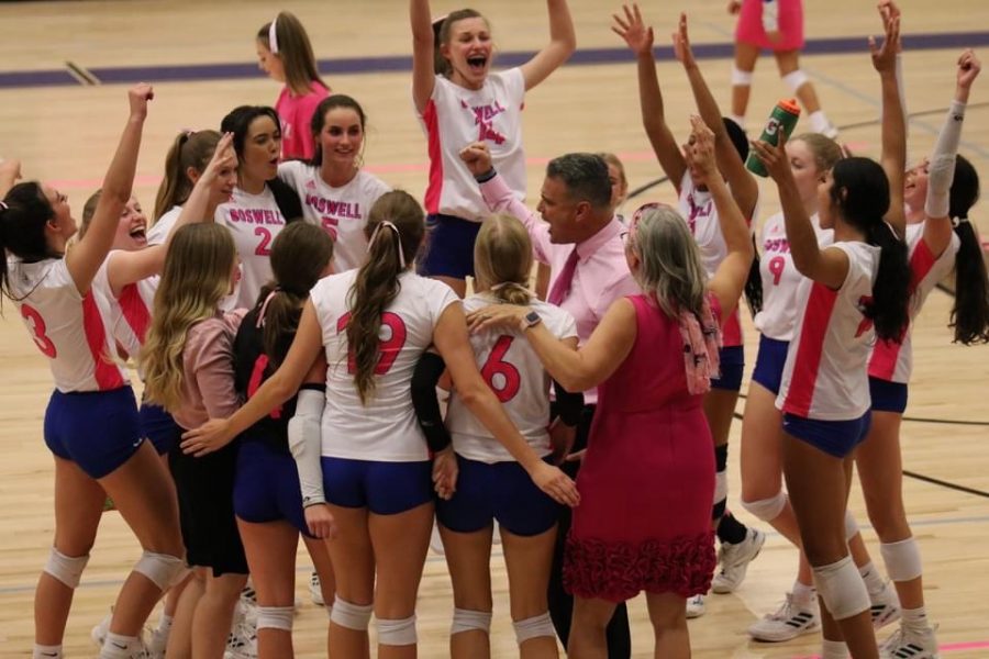 The Lady Pioneers, with coaches Rafael Lopez and Christina Rutiger, celebrate their district championship win on Oct. 15.