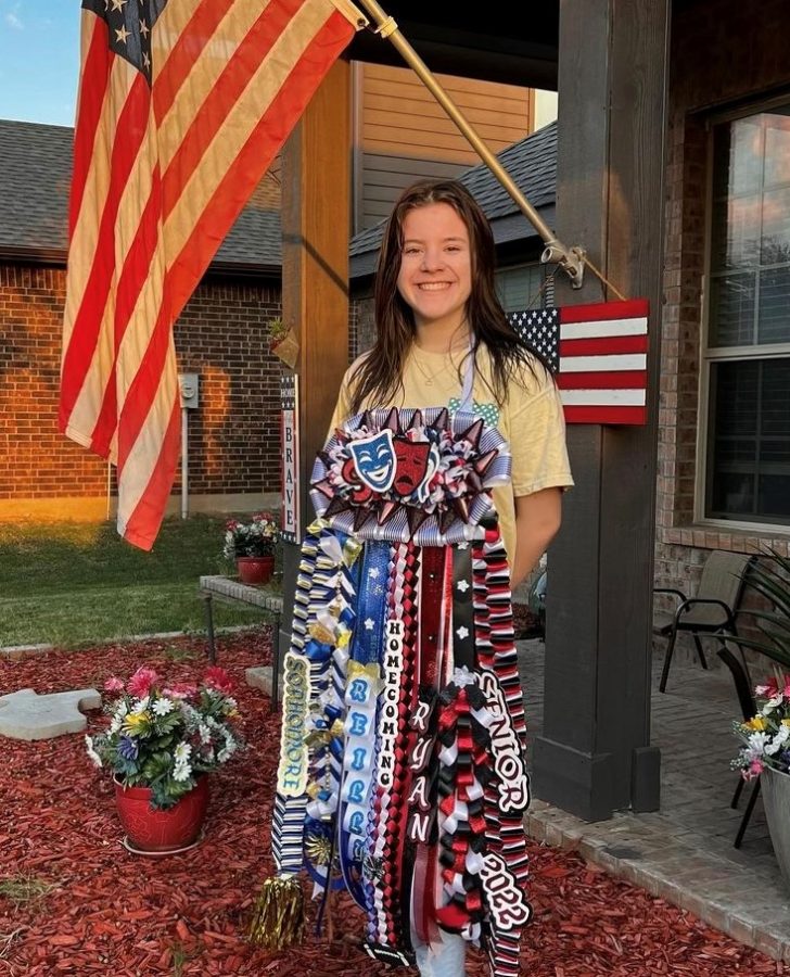 Sophomore Reilly McIntosh displays her homecoming mum that combines Boswell colors with those of her old school in North Dakota.