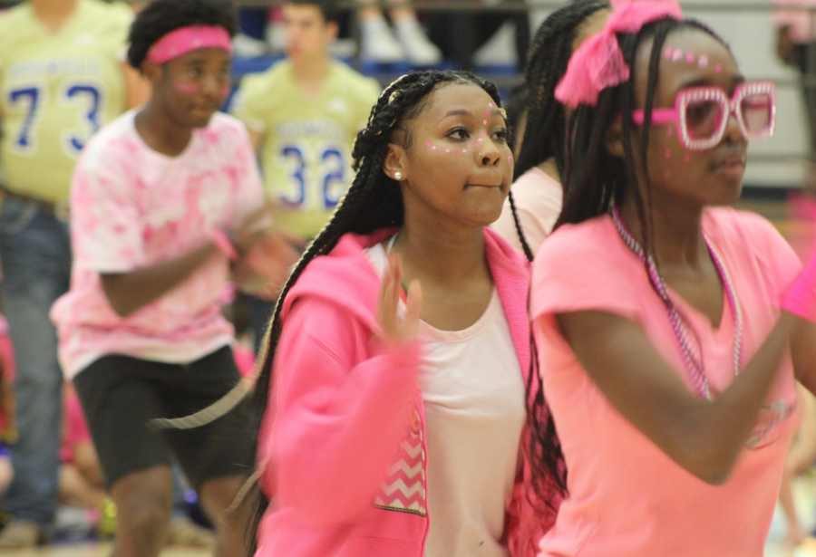 Golden Steppers DJ Savage, 10, Kevia Booker, 9, and Easter Likobe, 10, perform at the Pink Out pep rally. 