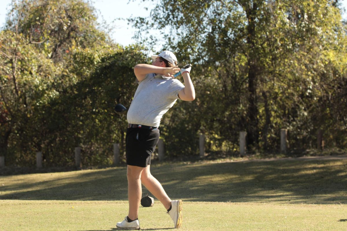 Junior Maddox Peters takes a swing at the Nov. 5 golf tournament at Southern Oaks Golf Club in Burleson. The golf team donated a portion of their fundraising to the Ronald McDonald House to benefit sick children.